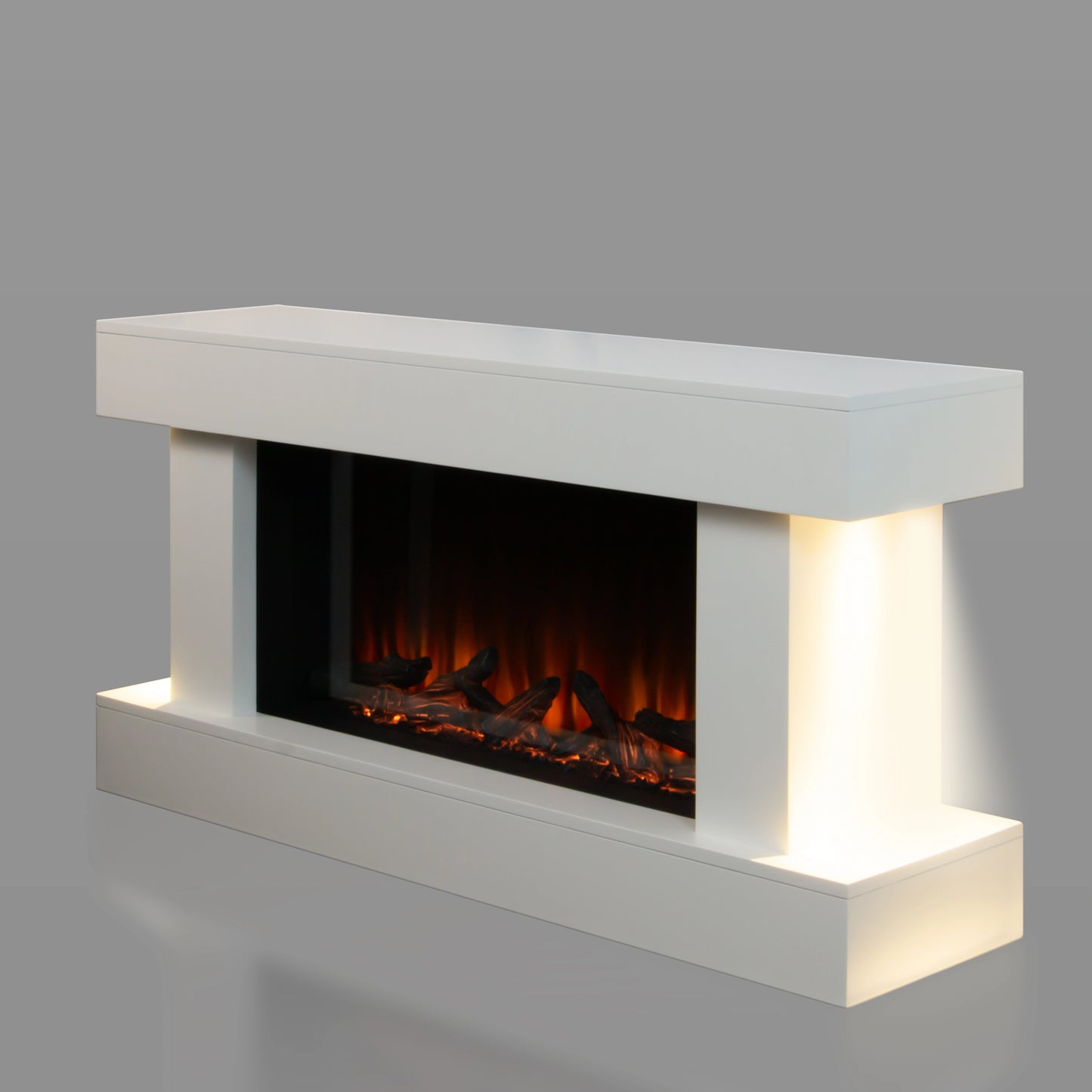Modern electric fireplace with white concrete mantle on a gray background, and ambient lighting on both sides.