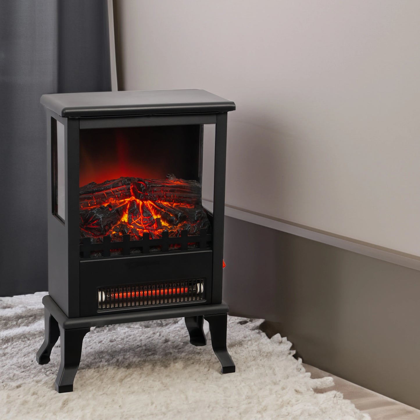 Black electric fireplace heater on a white rug with a neutral wall background