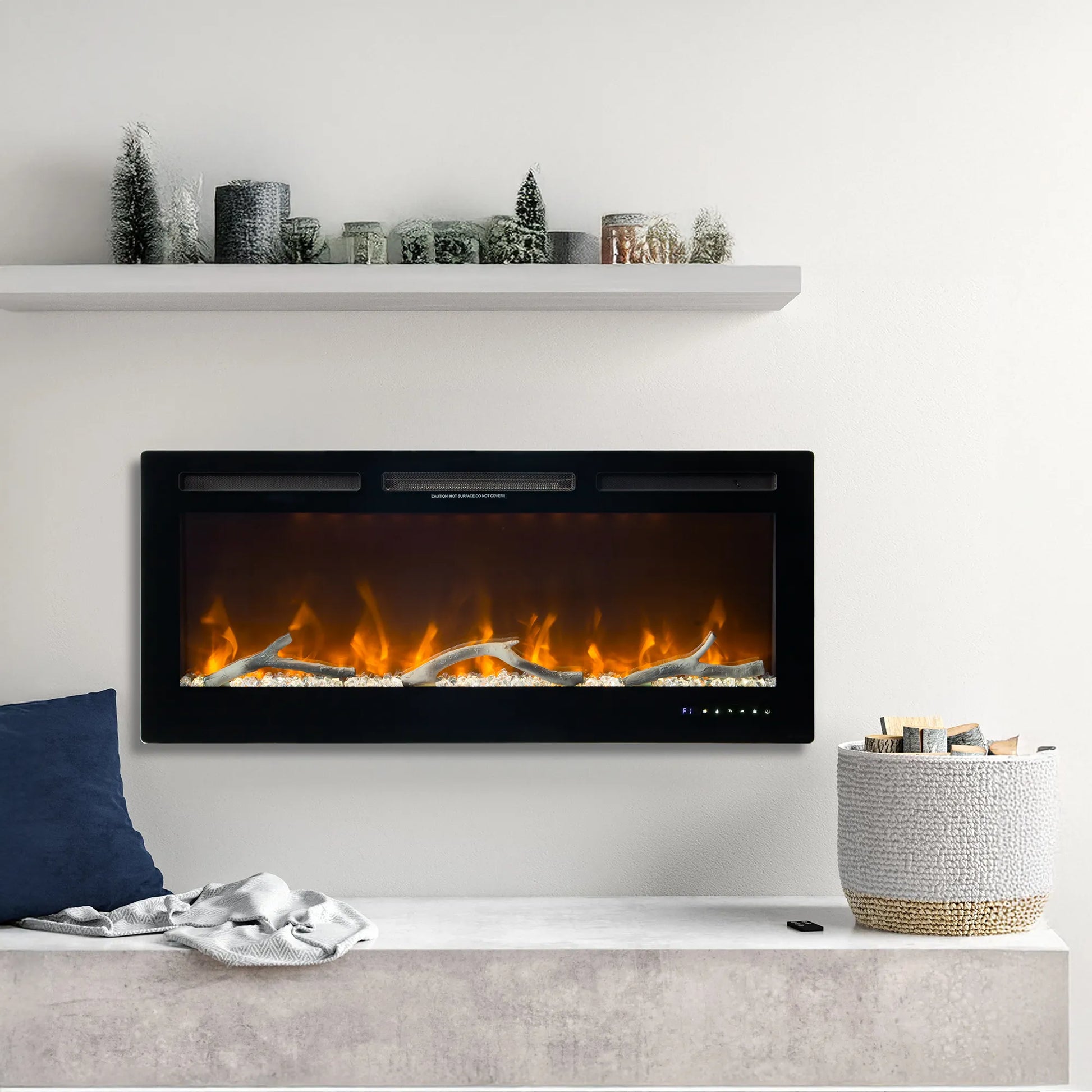 Modern electric fireplace with decorative items on a white wall