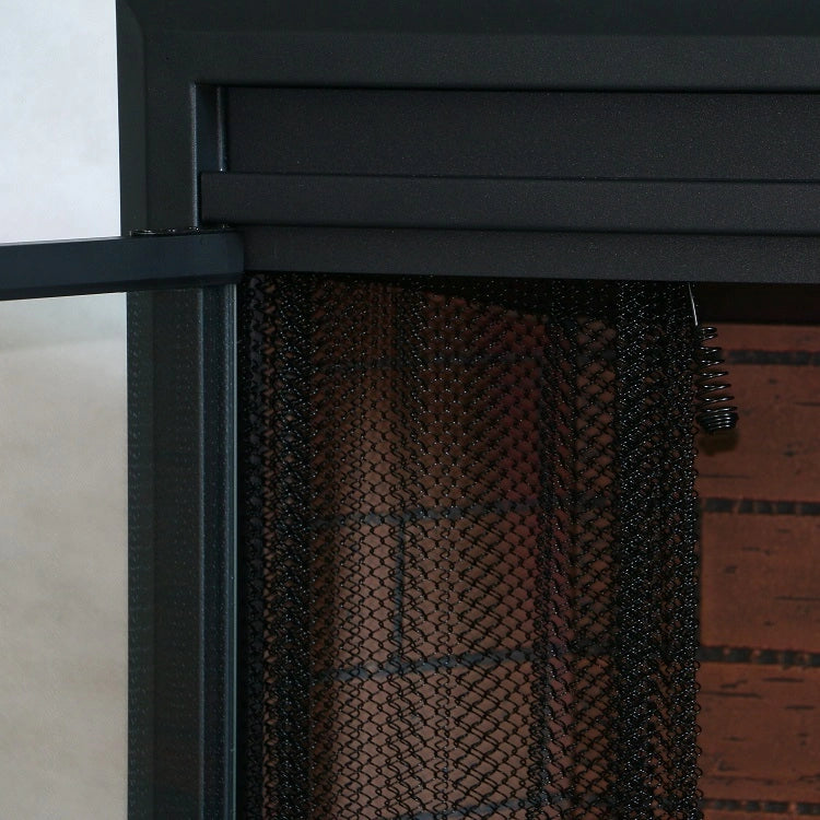 Close-up of a black metal fireplace with a textured black mesh curtain.
