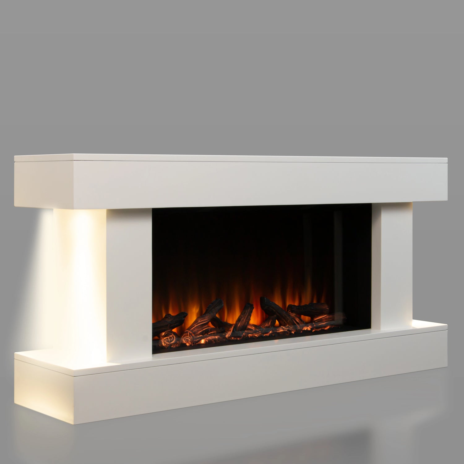 Modern electric fireplace with white surround on a gray background, ambient lighting on  both sides.