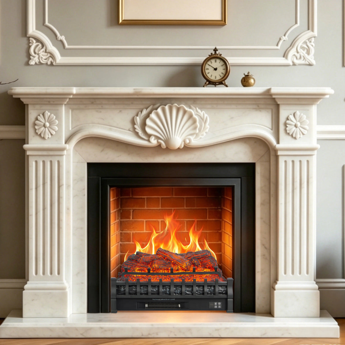 A white marble fireplace mantel with decorative molding, a black firebox insert, and a glowing electric fire with orange flames and embers. The fireplace is set against a light gray paneled wall with a small vintage clock and decorative object on the mantel.